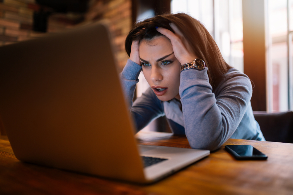 Frustrated woman dealing with a cyberattack.