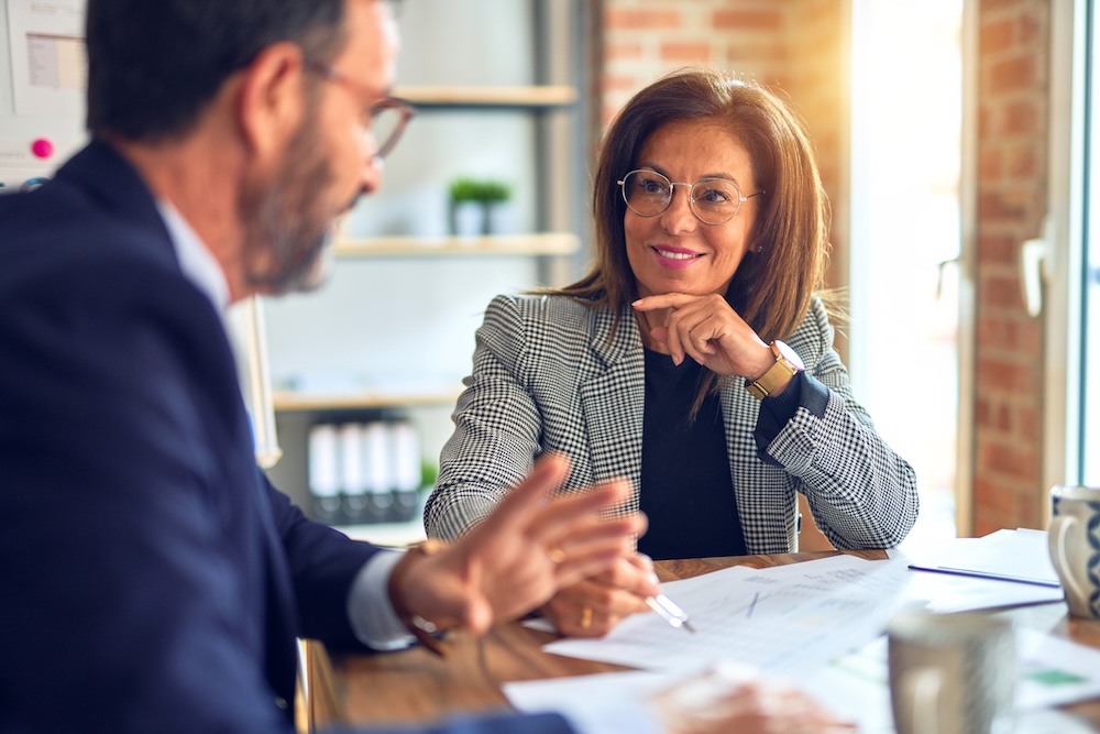 Two business people discussing Managed Print Services.  