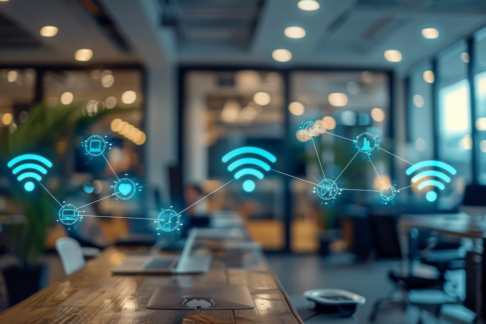 Illustration of connected devices and wireless network icons in a modern office, representing IoT and smart technology.
