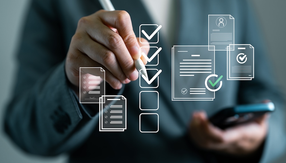 Document approval and business productivity tracking concept. Businesswoman using digital pen to check off virtual checklist on transparent screen, task management and ISO compliance